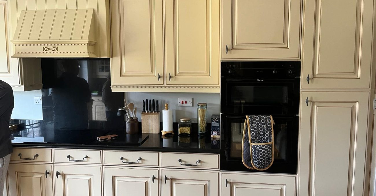 Dated cream kitchen doors and cooker hood in Yateley, Hampshire before the new Riva painted frontals were fitted