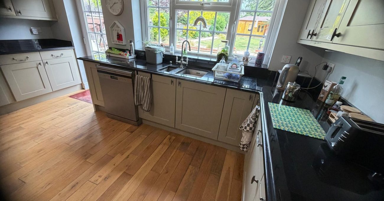 Completed kitchen door replacement in Yateley, Hampshire with new Riva painted frontals and the existing black granite worktops