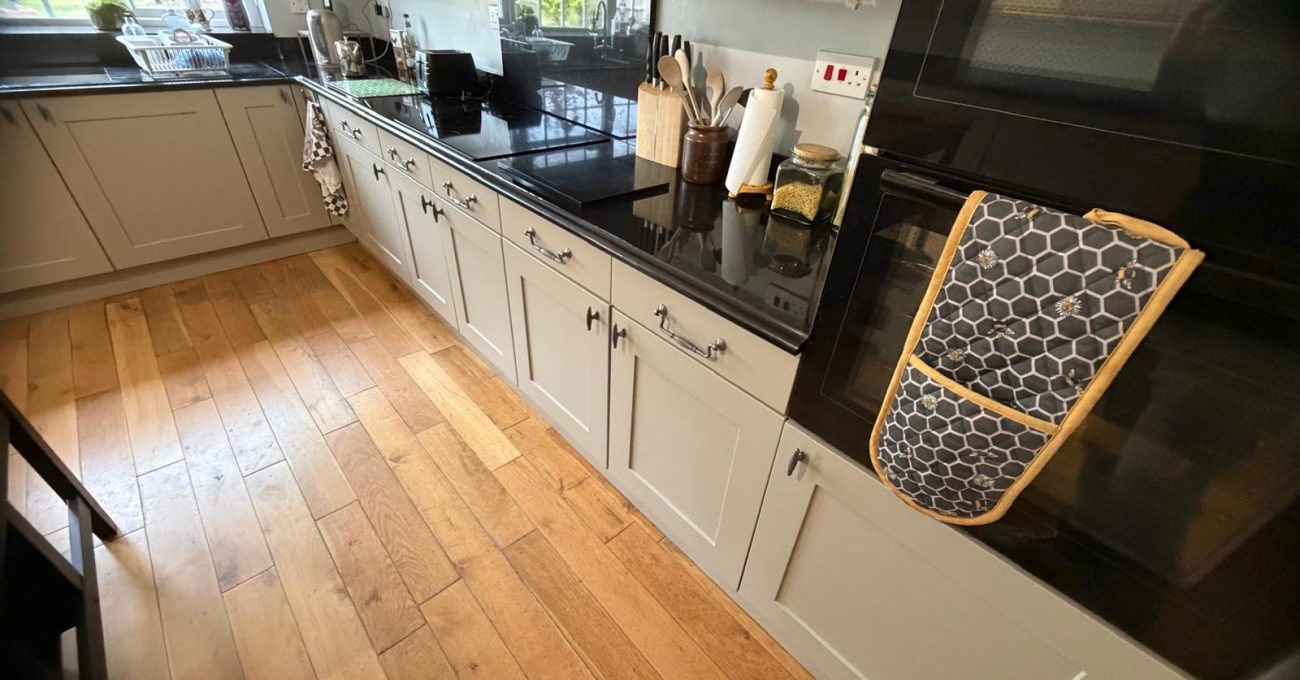 New Riva painted door and drawer frontals in Yateley, Hampshire with integrated double oven and retained granite worktop