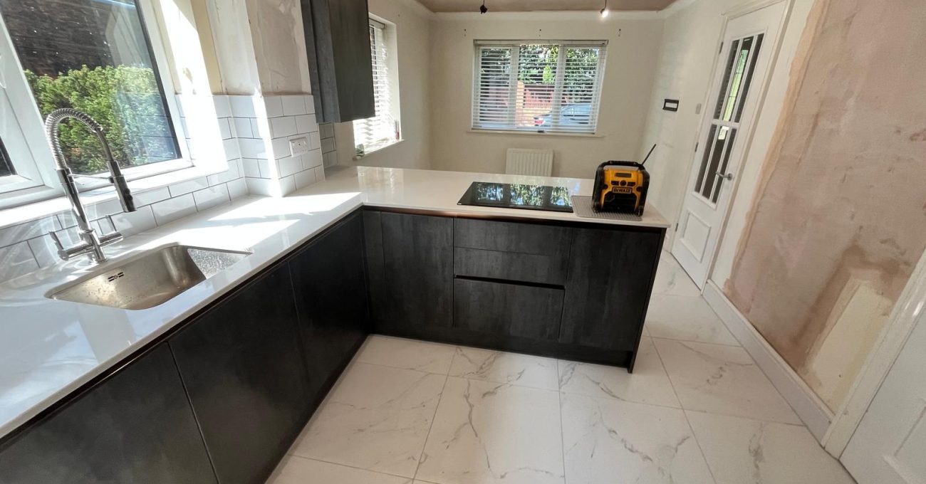 Completed kitchen run in Sandhurst, Berkshire with anthracite vinyl wrapped units, stone worktop and metro tile splashback