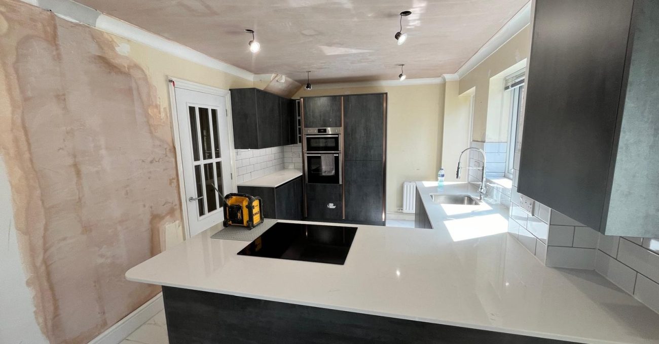 Open plan kitchen diner in Sandhurst, Berkshire showing the island hob and integrated oven housing