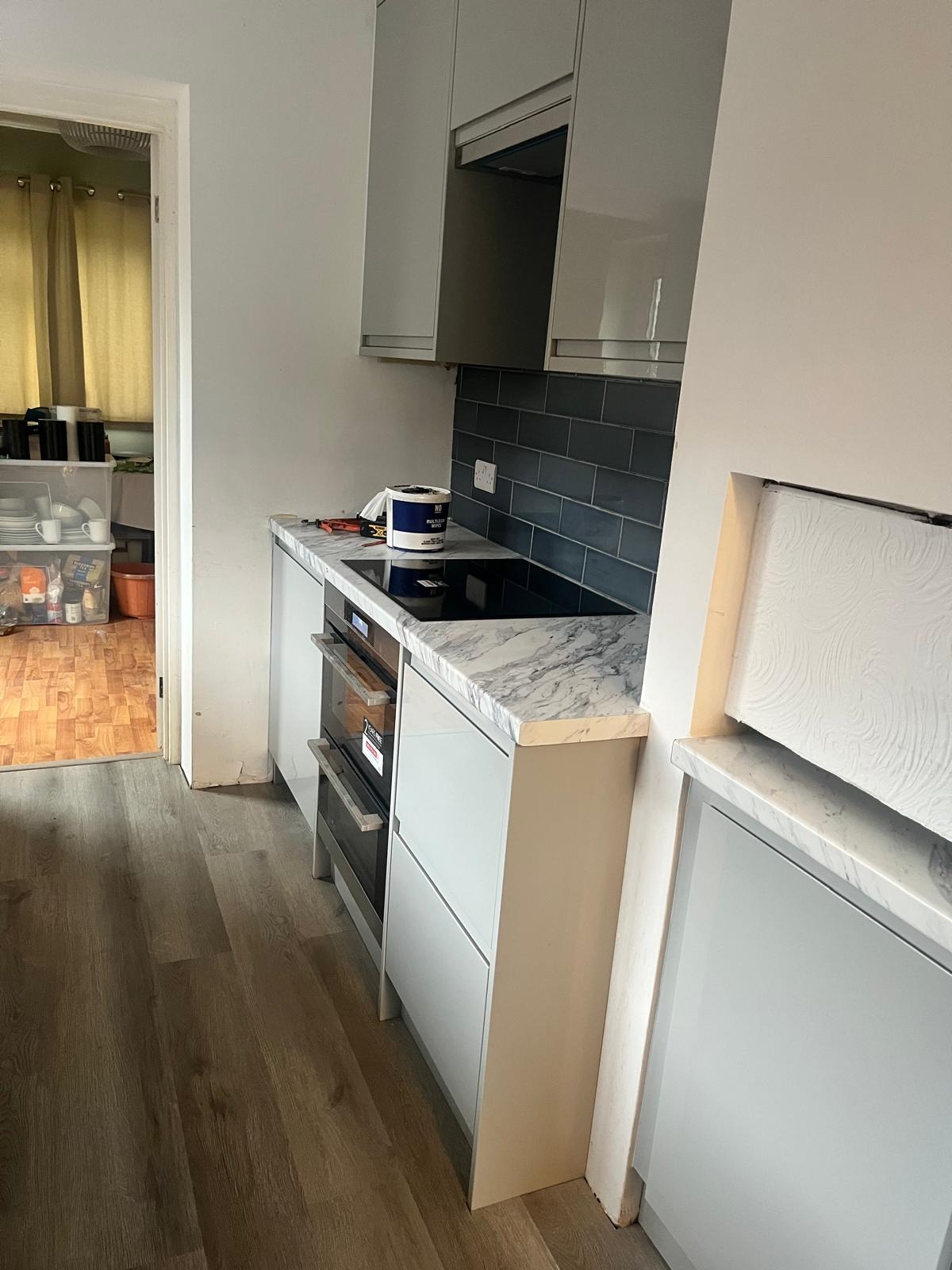 New Portofino kitchen in Guildford, Surrey with integrated oven, induction hob and marble-effect worktop